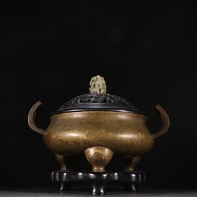 A three-legged aroma burner with a copper tire facing the sky