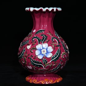 A Qing Qianlong carmine ground embossed pastel floral pattern melon edge bottle