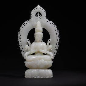 A white jade carving of the Qing Dynasty is a standing statue of Guanyin with a thousand hands