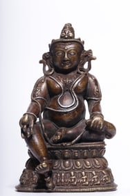 A seated statue of the God of Wealth in a silver yellow alloy copper file in the Qing Dynasty