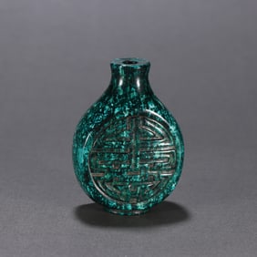 A Qing Dynasty snuff bottle with a dragon horn carved longevity character