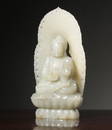 A seated statue of Shakyamuni carved in Hetian white jade in the Qing Dynasty