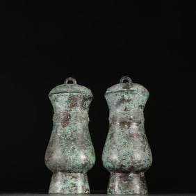 A pair of bronze cups