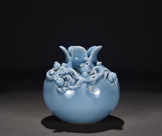 A Qing Qianlong celadon carved pomegranate statue