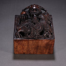 A Qing Dynasty agarwood dragon and phoenix button seal