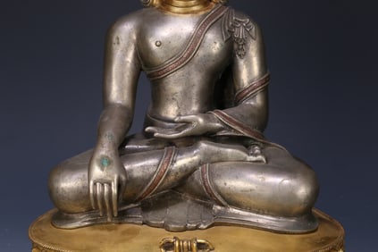 An 18th-century Tibetan Buddhist statue of Shakyamuni in sterling silver and gilt with copper