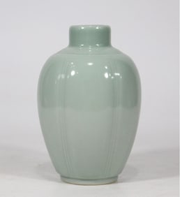 A Qing Kangxi year powdered celadon glazed melon edge bottle