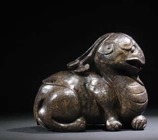 A Qing Dynasty Hetian jade carving to ward off evil spirits and auspicious beasts