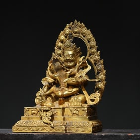 A bronze gilt red God of Wealth statue