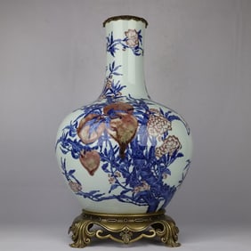 A blue and white glazed red nine peach picture inlaid with copper-rimmed celestial sphere vase