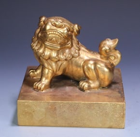 A large seal of a copper gilt lion button