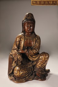 A Ming Dynasty copper tire gilt free Guanyin seated statue