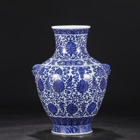 A Qing Dynasty Qianlong blue and white entwined lotus eight treasure pattern animal ear vase