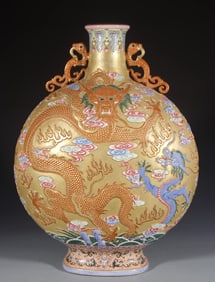 A Qing Qianlong binaural carved Canglong godson golden ground moon flat vase