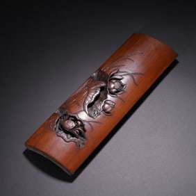A Qing Dynasty Buqing bamboo carved lotus pattern armrest