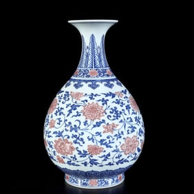 A Qing Dynasty entwined lotus blue and white glazed red jade pot spring vase