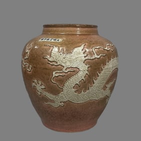 A sauce glaze carved dragon pattern jar of the Ming Dynasty
