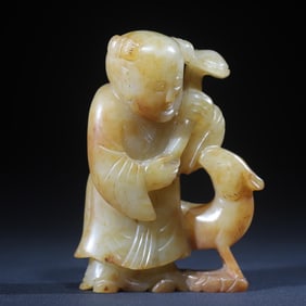 A Qing Dynasty green and white jade boy plays with deer and elegant play