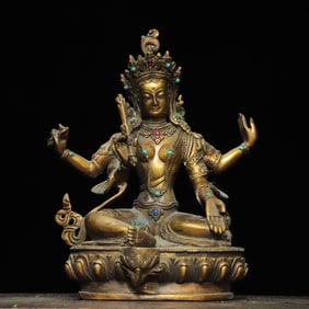 A bronze inlaid gemstone inlaid with a four-armed Guanyin statue