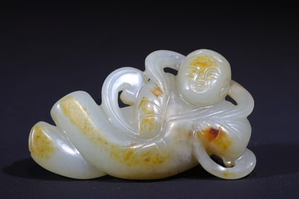 A Qing Dynasty gold-skinned flying boy pendant carved treasure