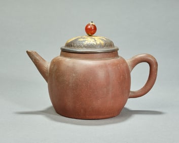 A Qing Dynasty purple clay pot with a silver gilt lid