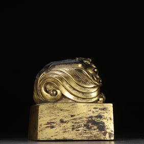 A copper gilt beast button seal