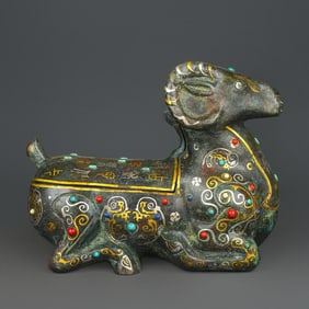A bronze gold and silver inlaid with multi-gemstone lying sheep from the Han Dynasty