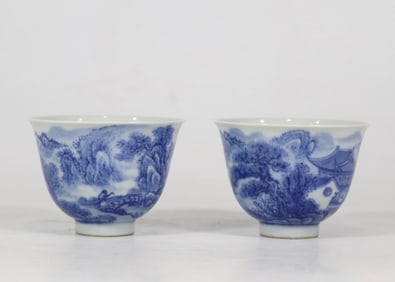 A pair of blue and white landscape cups made in the Qing Yongzheng era