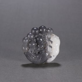 A Qing Dynasty blue and white seed squirrel grape carving