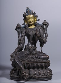 A seated statue of Tara with a golden face in copper clay in the Qing Dynasty