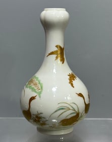 A Qianlong era of the Qing Dynasty enamel color-painted reed swallow garlic bottle