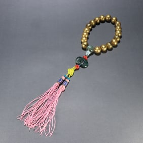 A piece of agarwood sealed with gold, held by eighteen sons