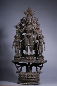 A three-seated statue of Guanyin holding a sword in a box of gold and bronze in the Qing Dynasty