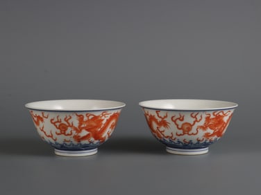 A pair of Qing Yongzheng year blue and white alum red sea water double dragon chasing pearl cups