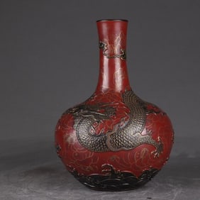A Qing Qianlong bronze coral red carved Canglong godson heavenly ball vase