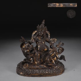 A seated statue of the King of Treasure in the Qing Dynasty cast copper tire clay