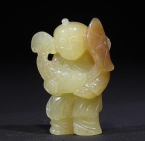 A skillfully carved topaz boy pendant from the Qing Dynasty