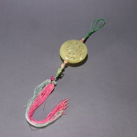 A Qing Dynasty Hetian topaz entwined lotus sachet pendant