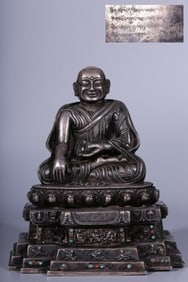 A seated statue of a bronze gilt silver guru in the Qing Dynasty