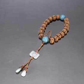 A piece of Qing Dynasty agarwood inlaid silver gilt longevity pattern eighteen sons hand