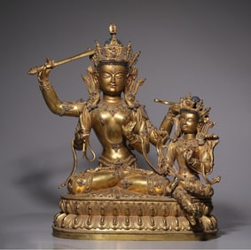 A Qing Dynasty copper-gilt four-armed Manjushri double-body Buddha