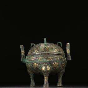 A bronze three-legged tripod with gold and silver