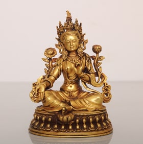 A copper-gilt green Tara ornament