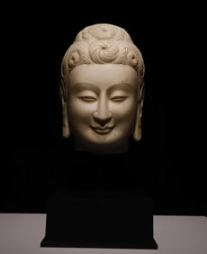 A piece of Northern Wei white jade Buddha head