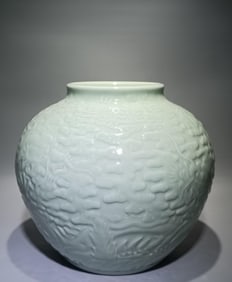 A Qing Qianlong model bean celadon carved Canglong godson Xiangyun Shoushan Fuhai pattern jar