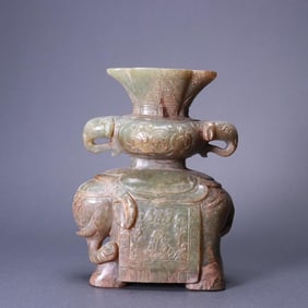 A piece of ancient jade is peaceful with an elephant incense insert