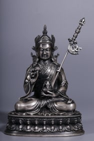 A seated statue of a copper-gilt anemony peanut in the Qing Dynasty