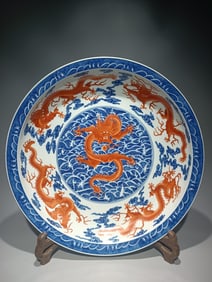 A Qing Qianlong model blue and white alum red Kowloon sea pattern plate