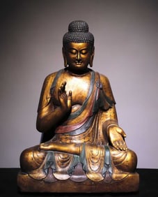A Tang bluestone gilt painted Buddha statue