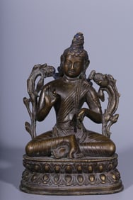A seated statue of Tara in a Qing Dynasty box gold and bronze box